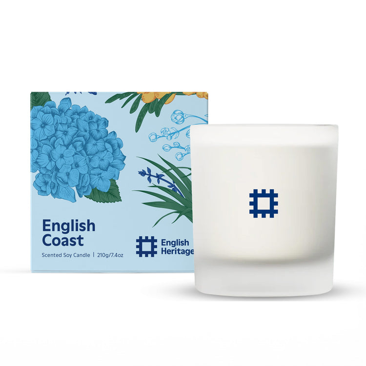 The English Heritage English Coast candle by Home County Co. is shown next to its illustrated candle box.