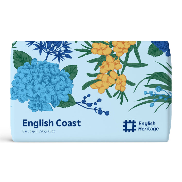 An English Heritage soap bar inspired by the English Coast is shown in its beautiful coastal illustrated paper soap wrap