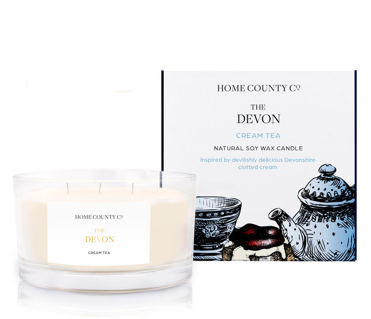 A cream tea scented 3 wick candle from the Home County Co. is shown next to its eco-friendly candle packaging box.