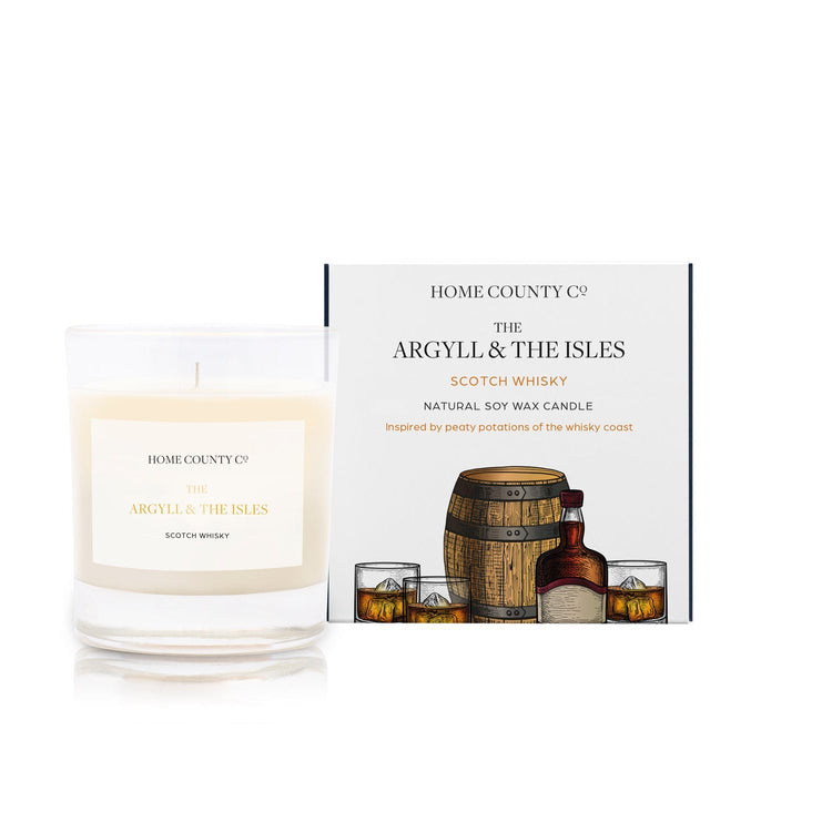 A scotch whisky scented candle from the Home County Co is shown with its eco-friendly packaging