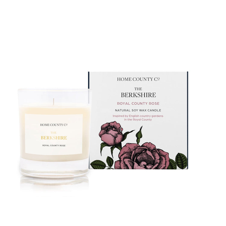 Home County Co. Berkshire rose scented candle shown with pink rose and candle packaging