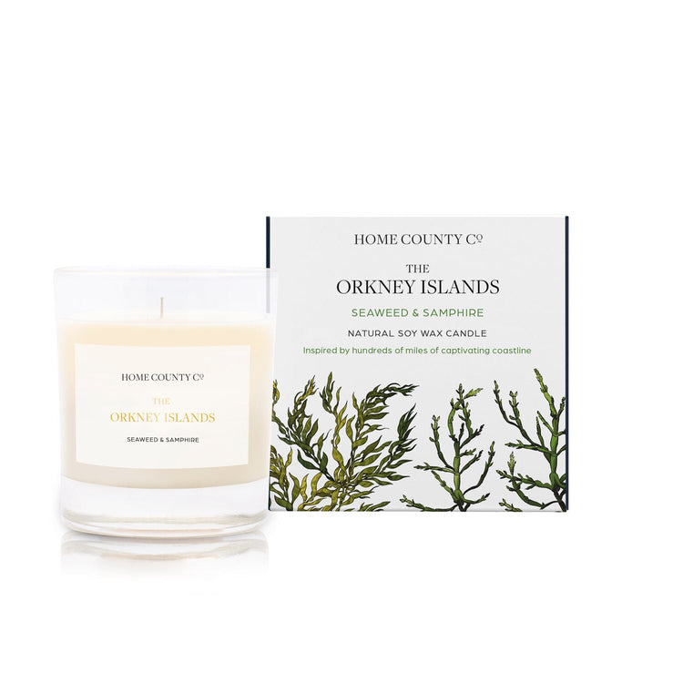 A seaweed and samphire scented candle from Home County Co. The cotton wick soy candle is shown next to the eco friendly box packaging.