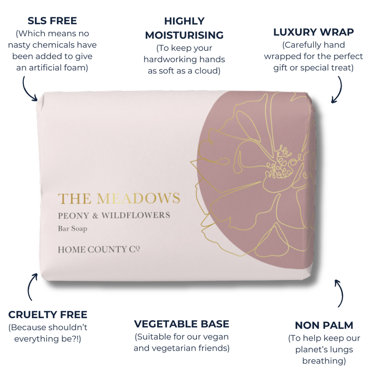 A floral scented soap bar from the Home County Co. is shown in a gold foil wrap with sustainable soap bar features. SLS free soap bar, cruelty free soap bar, vegan friendly soap bar, non palm soap bar.