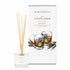 An Irish whiskey scented reed diffuser from Home County Co. The vegan friendly reed diffuser is shown next to the eco friendly reed diffuser box packaging.