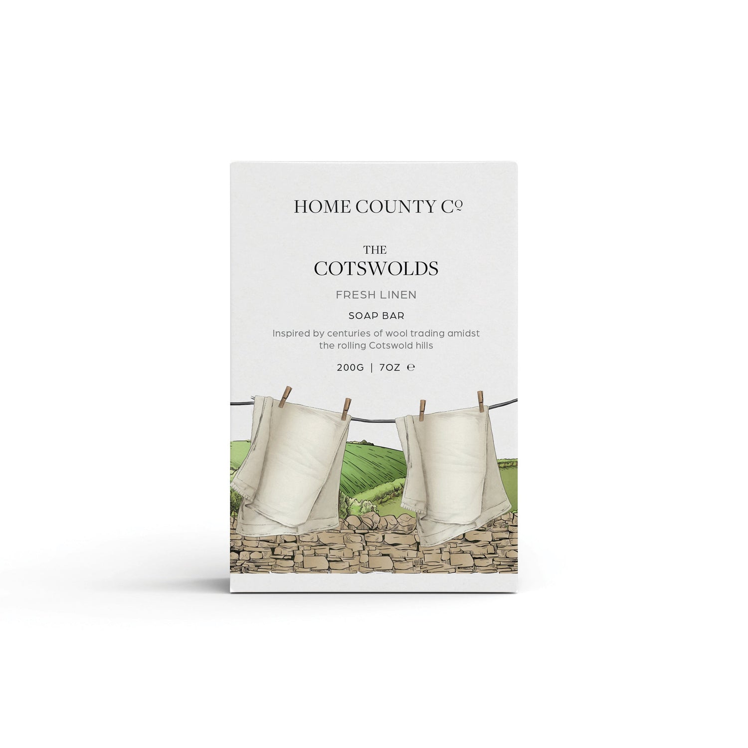 A fresh linen scented natural soap bar from the Home County Co. is shown in its clean sheets illustrated recyclable soap bar wrap