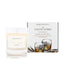 An Irish whiskey scented candle from Home County Co. The cotton wick soy candle is shown next to the eco friendly box packaging.