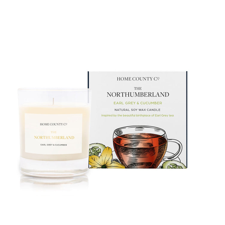 An Earl Grey and cucumber scented candle from Home County Co. The cotton wick soy candle is shown next to the eco friendly candle box packaging.