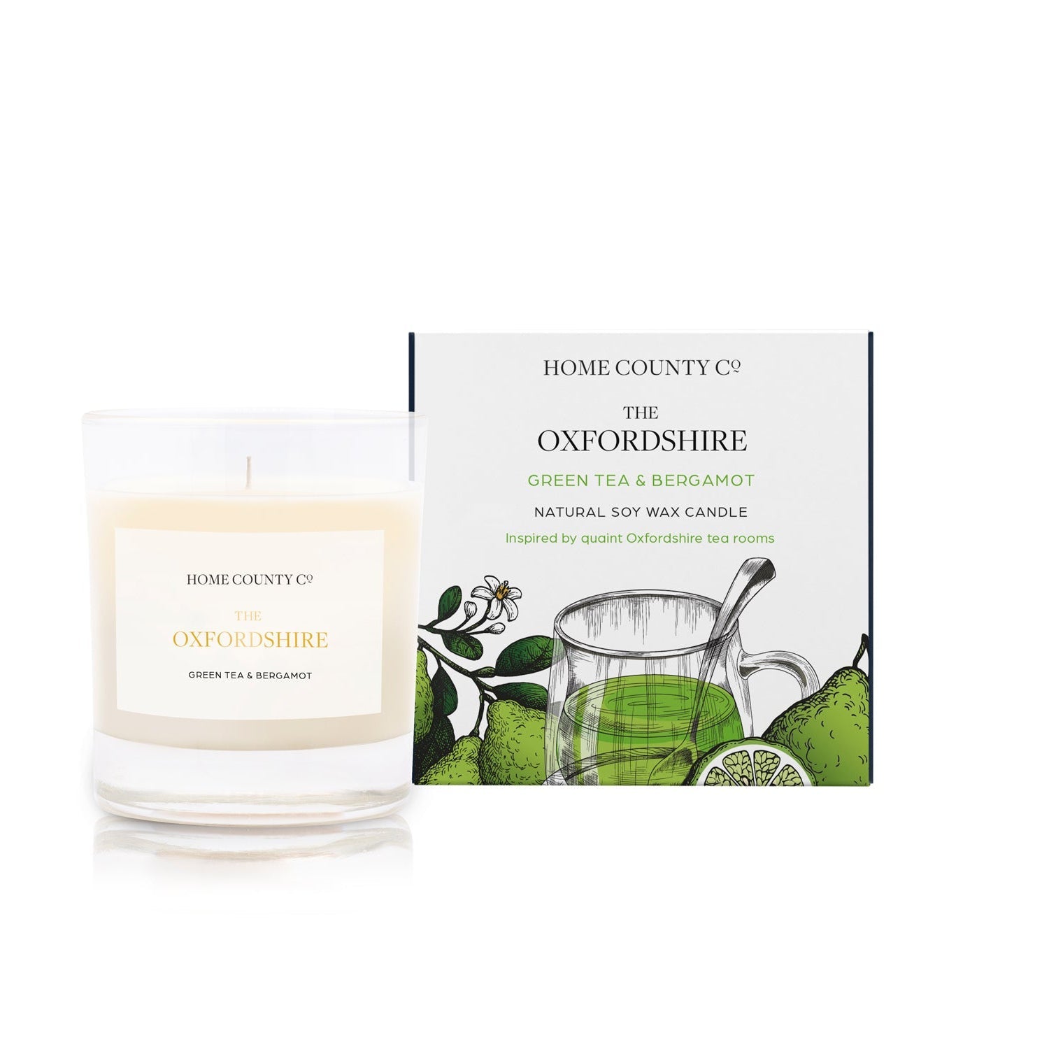 A green tea and bergamot scented candle from Home County Co. The cotton wick soy candle is shown next to the eco friendly candle box packaging.