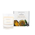 An amber and sweet orange scented candle from Home County Co. The cotton wick soy candle is shown next to the eco friendly candle box packaging.